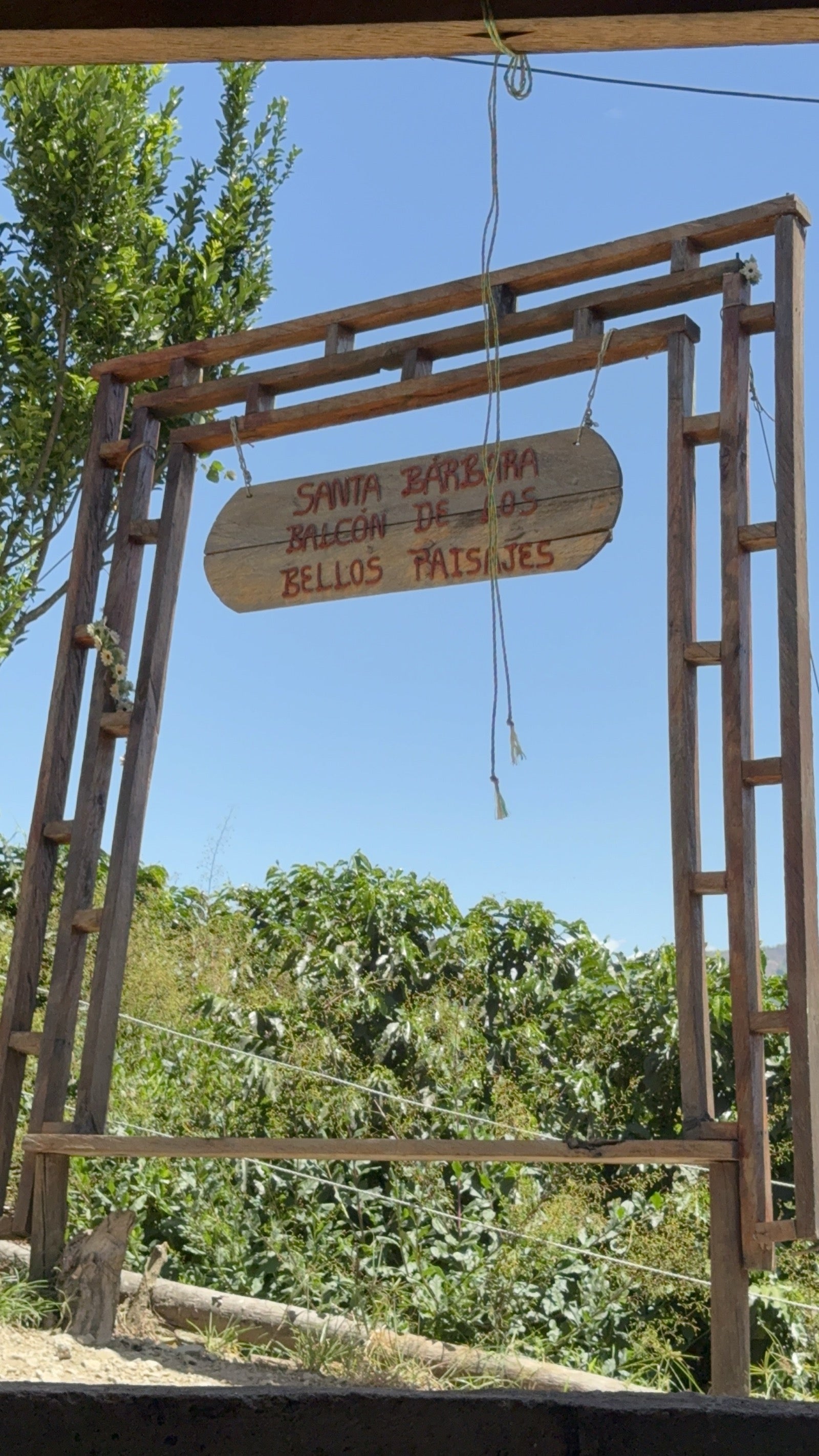 Wooden entrance sign at the farm in Santa Barbara, Antioquia