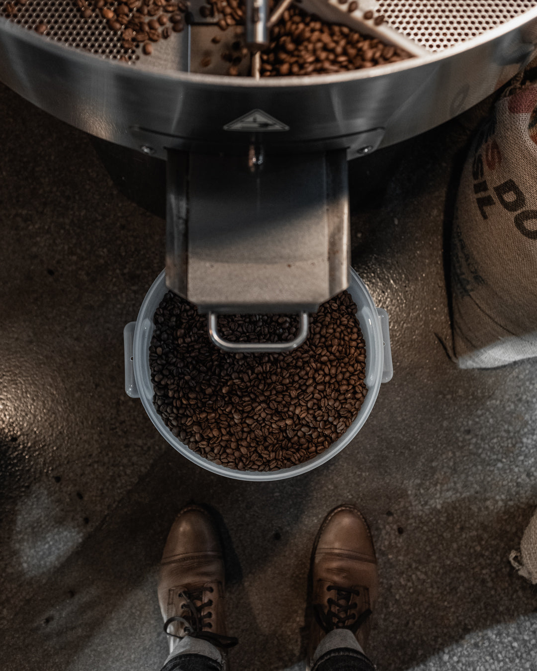 Overhead view of roasted coffee dropping from the Diedrich roaster into the cooling tray