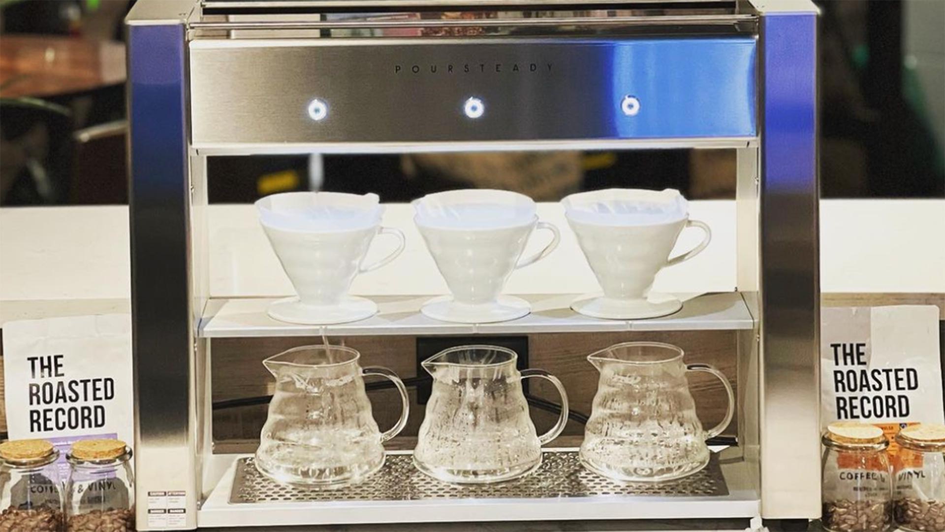 Glass pour-over drippers on the brew bar at The Roasted Record