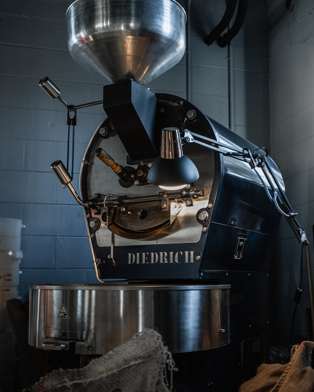 Diedrich coffee roaster under workshop light at The Roasted Record roastery