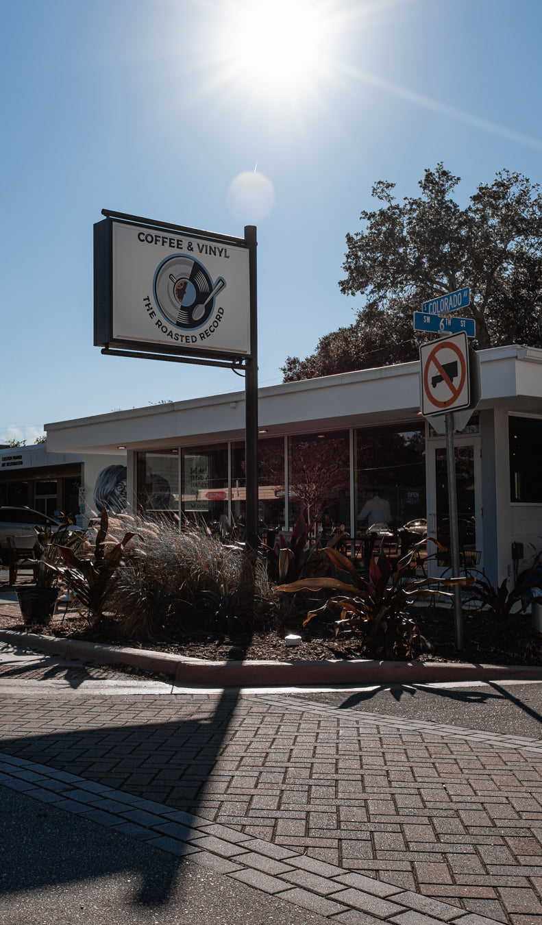 The Roasted Record coffee and vinyl storefront sign in downtown Stuart, Florida
